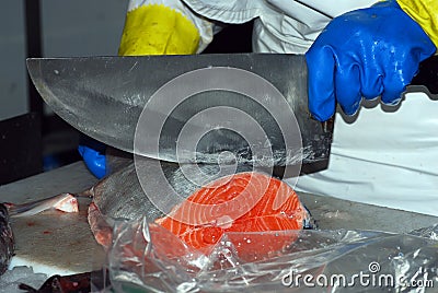 A vendor cutting fish at the Boqueria market Stock Photo