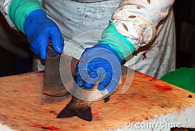 A vendor cutting fish at the Boqueria market Stock Photo