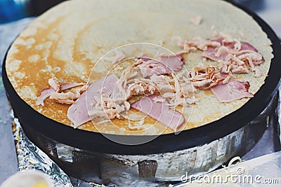 Vendor making crepe with ham outdoors Stock Photo