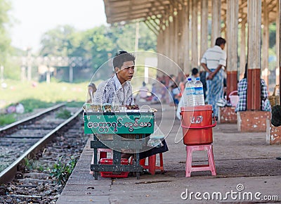 Vendor at a railway station in Yangon, Myanmar. Editorial Stock Photo