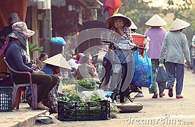 Vendor selling greens in market in Hoi An Editorial Stock Photo