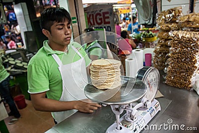Vendor selling maize tortillas on a local market in Merida, Yu Editorial Stock Photo