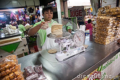 Vendor selling maize tortillas on a local market in Merida, Yu Editorial Stock Photo