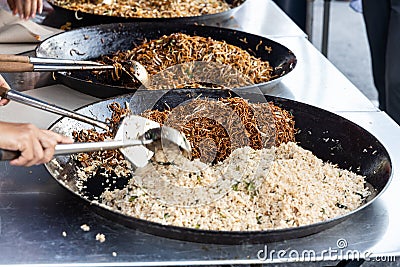 Vendor selling simple fried rice noodle in street market bazaar Stock Photo