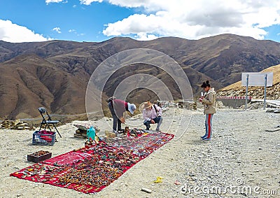 Vendor selling Tibetan stones, beads and souvenirs Editorial Stock Photo