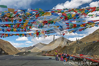 Vendor selling Tibetan stones, beads and souvenirs along the Kampala Pass in Tibet Autonomous Region Editorial Stock Photo