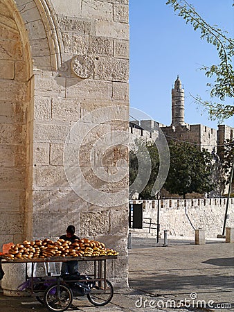 Vendor sits at the Jaffa Gate entrance to the walled Old City of Jerusalem Editorial Stock Photo