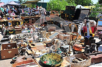 Vendor waiting for buyers. He is selling used/old decorative dishes at Wroclaw Flea Market Editorial Stock Photo