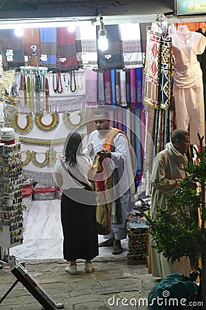 Vendors entice tourists to buy clothing and other souvenirs Editorial Stock Photo