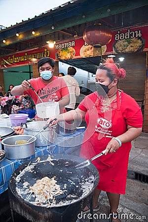 Vendors prepare food on a hot pan in the market Editorial Stock Photo