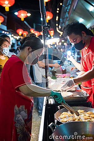 Vendors prepare food in the market Editorial Stock Photo