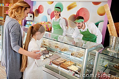 Vendors serves customers in candy store Stock Photo