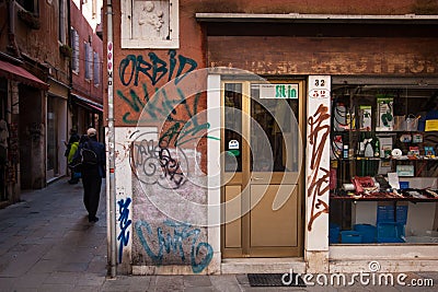 Venetian backstreet shop with Grafitti Editorial Stock Photo