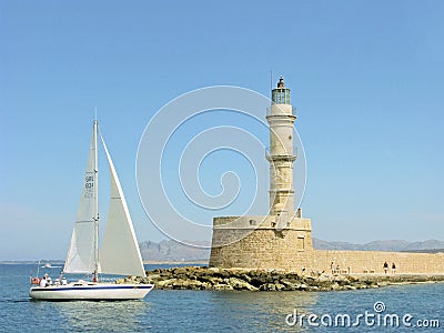 Venetian lighthouse in Chania town and yacht wih people Editorial Stock Photo