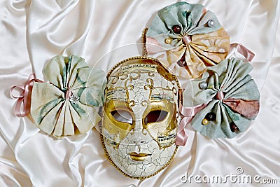 Venetian mask Volto and textile rosettes with ribbons Stock Photo