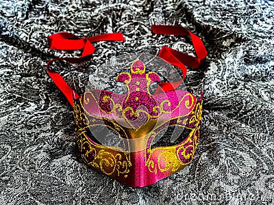 Venetian masquerade carnival mask in red, purple and gold Stock Photo