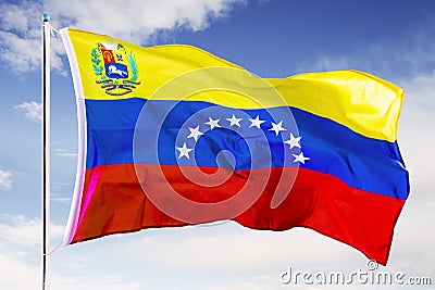 Venezuela national flag waving under blue sky Stock Photo