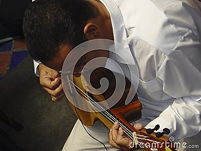 Venezuelan folklore musician Ismael Querales playing the bandola Editorial Stock Photo