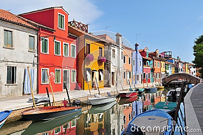 Venice Burano island canal small colored houses and the boats in sunny summer day, Italy Stock Photo