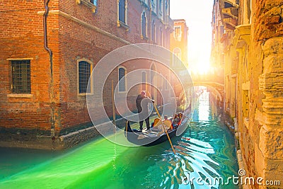 Venice canal, gondola and gondolier with tourists traveling by water in the town Editorial Stock Photo