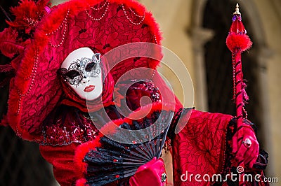 VENICE, FEBRUARY 10: An unidentified woman in typical red dress poses during traditional Venice Carnival Editorial Stock Photo