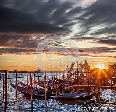 Venice with gondolas against colorful sunset in Italy Editorial Stock Photo