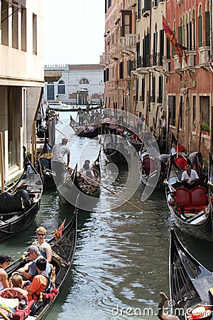 Venice Gondolier floating on a traditional venetian canal Editorial Stock Photo