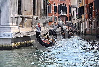 Venice city with gondoliers and gondolas with tourists, Italy Editorial Stock Photo