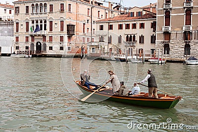 Tourists rowing along the Venice canal Editorial Stock Photo