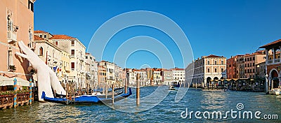 Venice, Italy - August 14, 2017: Giant hands up from the water of the Grand Canal to support the building. This powerful report on Editorial Stock Photo