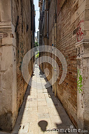 VENICE, ITALY - August 02, 2019: Narrow pedestrian streets of Venice bitween the channels. Some quiet places almost without people Stock Photo