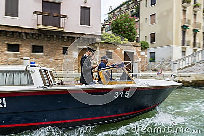 Water gendarmerie on a boat patrols canals of the city of Venice Editorial Stock Photo