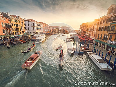 Venice, Italy - 17.10.2023: Busy water traffic with boats, taxi and gondolas in Rialto bridge area of the Grand channel. Warm Editorial Stock Photo