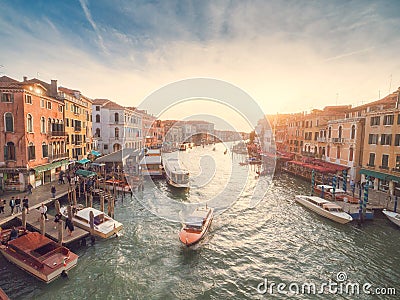 Venice, Italy - 17.10.2023: Busy water traffic with boats, taxi and gondolas in Rialto bridge area of the Grand channel. Warm Editorial Stock Photo