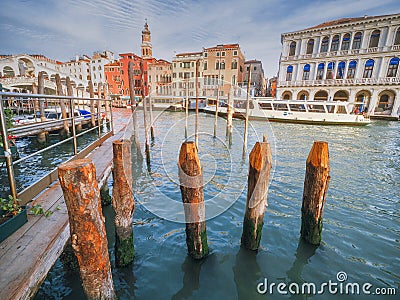 Venice, Italy - 17.10.2023: Colorful buildings by the Grand channel in Rialto bridge area with shops and restaurants. Warm sunny Editorial Stock Photo