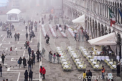 Venice Italy elevated day view of tourists on Saint Mark main square, around famous cafe bistro outdoor Editorial Stock Photo