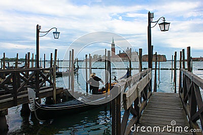 Venice/Italy 2020: Gondolier leaving his gondola at the berth in Venice Editorial Stock Photo