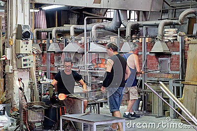 Glassmakers wotking at a factory on the island of Murano near Venice Editorial Stock Photo