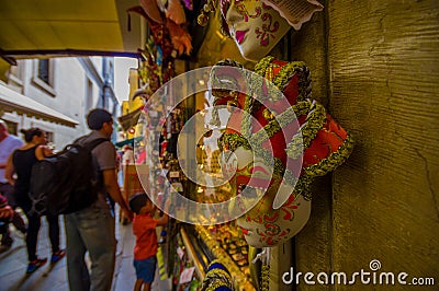 VENICE, ITALY - JUNE 18, 2015: Red and gold beautiful mask in a souvenir shop in Venice, selective focus. Turists Editorial Stock Photo