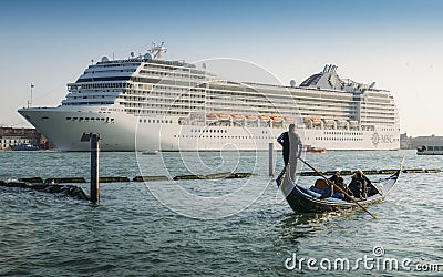 Juxtaposition of gondola and huge cruise ship in Giudecca Canal. Old and new transportation on the Venice Lagoon Editorial Stock Photo