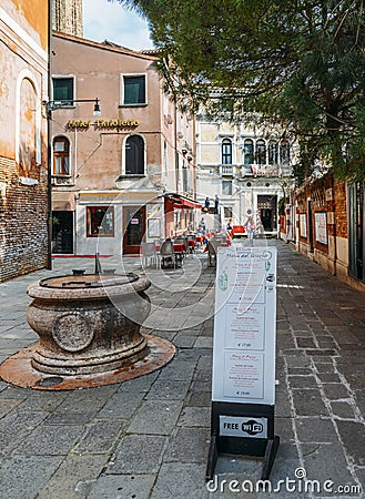 A menu in both English and Italian in front of a restaurant in the historic centre of Venice Editorial Stock Photo