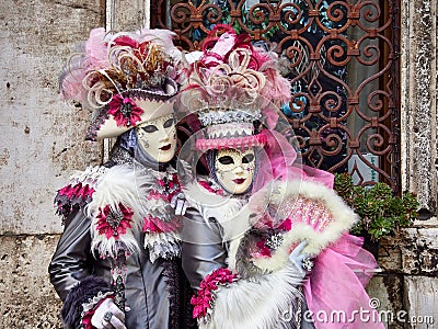 Venice, Italy - March 1, 2019 Two person dressed with typical Venice Costumes pose for a photo Editorial Stock Photo