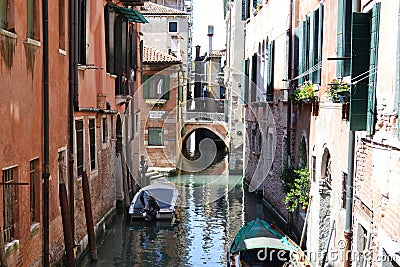 Canal streets of Venice with motorboats anchored at walls of old houses. Editorial Stock Photo