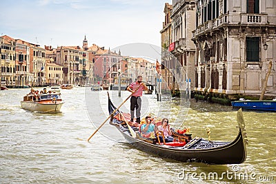 Gondola with people sails on Grand Canal in sunny Venice Editorial Stock Photo