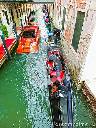 Venice, Italy - May 04, 2017: gondola sails down the channel in Venice, Italy. Gondola is a traditional transport in Editorial Stock Photo