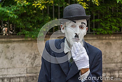 VENICE, ITALY - May 24, 2016: Male mime looking like a Charlie Chaplin in Venice with white glove and dark hat. Street male mime Editorial Stock Photo