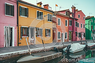 Senior local man relaxing in the morning . Local traditional scene from Burano, Italy Editorial Stock Photo