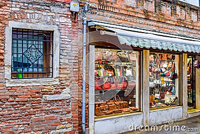 Storefront of brick wall Italian retail shop selling bags in Venice, Italy Editorial Stock Photo