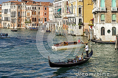 Gondolier plying his trade on the Grand Canal Venice on October 12, 2014. Unidentified people Editorial Stock Photo