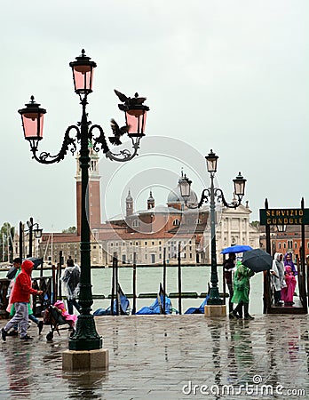 Tourists on a rainy day in Piazza San Marco St Marks Square. Editorial Stock Photo